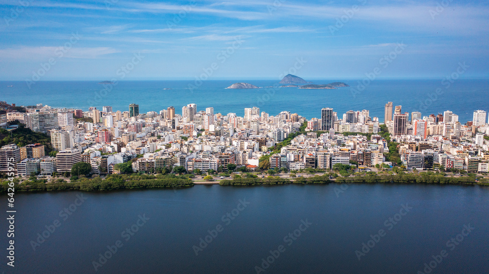 Aerial drone view of Rodrigo de Freitas Lagoon, Ipanema and Leblon neighborhoods and beaches. In the background are the Cagarras Islands.