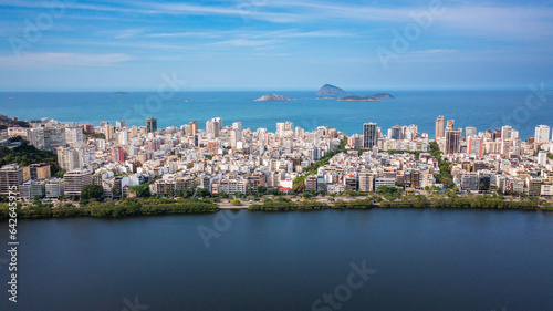 Aerial drone view of Rodrigo de Freitas Lagoon, Ipanema and Leblon neighborhoods and beaches. In the background are the Cagarras Islands.