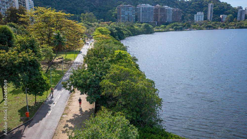 Fototapeta premium Aerial view of the leisure area and running track at Lagoa Rodrigo de Freitas, where people are jogging and exercising on a beautiful winter's morning in Rio de Janeiro.