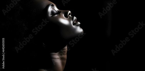 portrait, black woman's face on a black background, close-up, fashion photography, black and white effect, cosmetics