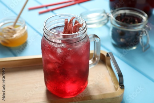 Wallpaper Mural Mason jar of delicious iced hibiscus tea on light blue wooden table Torontodigital.ca