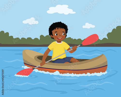 Little African boy rowing in the river