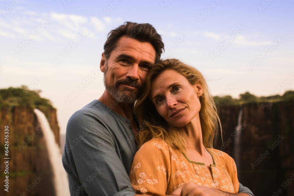 Couple in their 40s at the Victoria Falls in Zambia/Zimbabwe Couple in their 40s at the Victoria Falls in Zambia/Zimbabwe