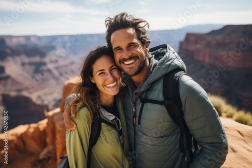 Couple in their 30s smiling at the Grand Canyon in Arizona USA