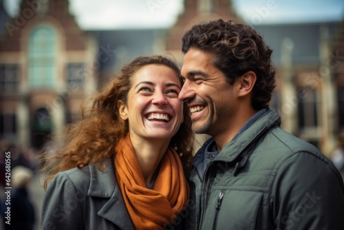 Couple in their 30s smiling at the Rijksmuseum in Amsterdam Netherlands