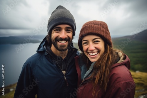 Couple in their 30s smiling at the Loch Ness in Scottish Highlands Scotland