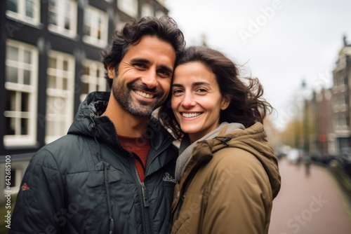 A couple in their 30s smiling at the Anne Frank House in Amsterdam Netherlands