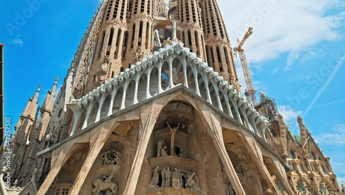 Beautiful view of La Sagrada Familia Basilica in Barcelona Spain in Europe. The most famous tourist attraction and landmark in Catalonia with museum and city views on a sunny day with a blue sky.