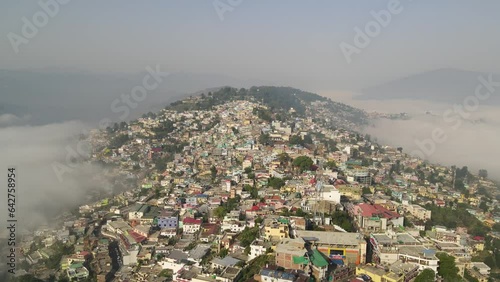 Aerial shot of a taxi driving down the roads of uttarakhand.  photo