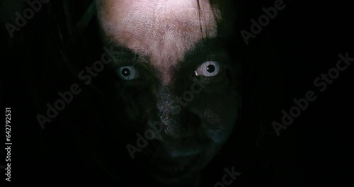 Horror scene of a mysterious Scary closeup Asian ghost woman creepy have hair covering the face looking to camera at abandoned house with background dark scene movie at night, festival Halloween photo