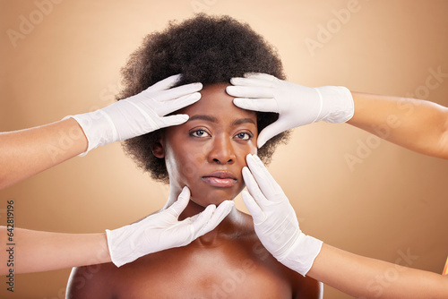 Skincare, hands and portrait of a black woman for botox, plastic surgery or face inspection. Medical, African person and doctors touching for facial check or dermatology on a studio background
