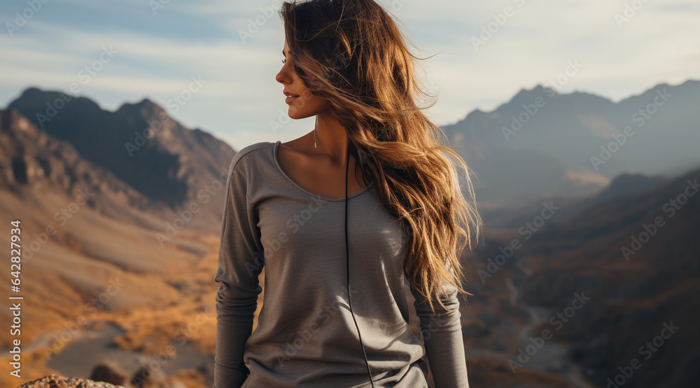 Portrait of a beautiful young woman on the background of mountains