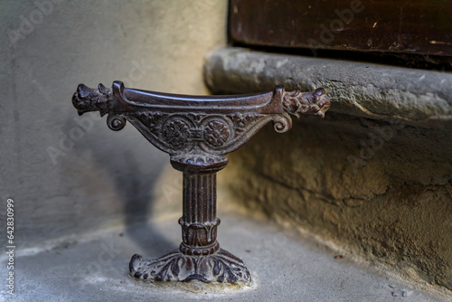 Fototapeta Naklejka Na Ścianę i Meble -  Ornate medieval metail boot scraper on a street in Oltrarno Santo Spirito area of Centro Storico or Historic Centre of Florence, Italy