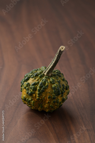 decorative pumpkins on walnut wood table photo