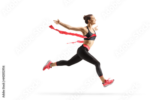 Fototapeta Naklejka Na Ścianę i Meble -  Full length profile shot of a female athlete finishing a race