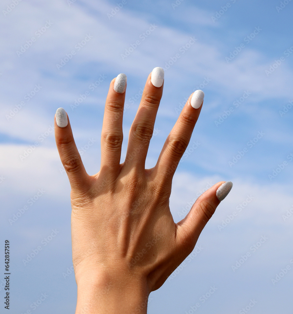 Beautiful hand of the girl with colorful nail polish on nails Beautiful hand of the girl with colorful nail polish on nails