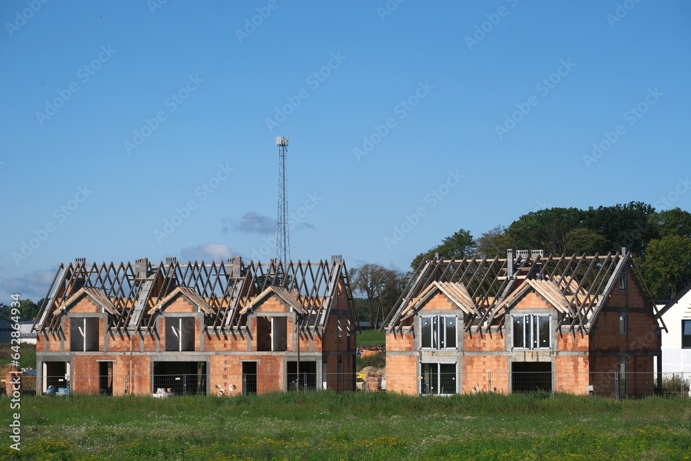 Fototapeta premium Building a house in a housing estate outside the city