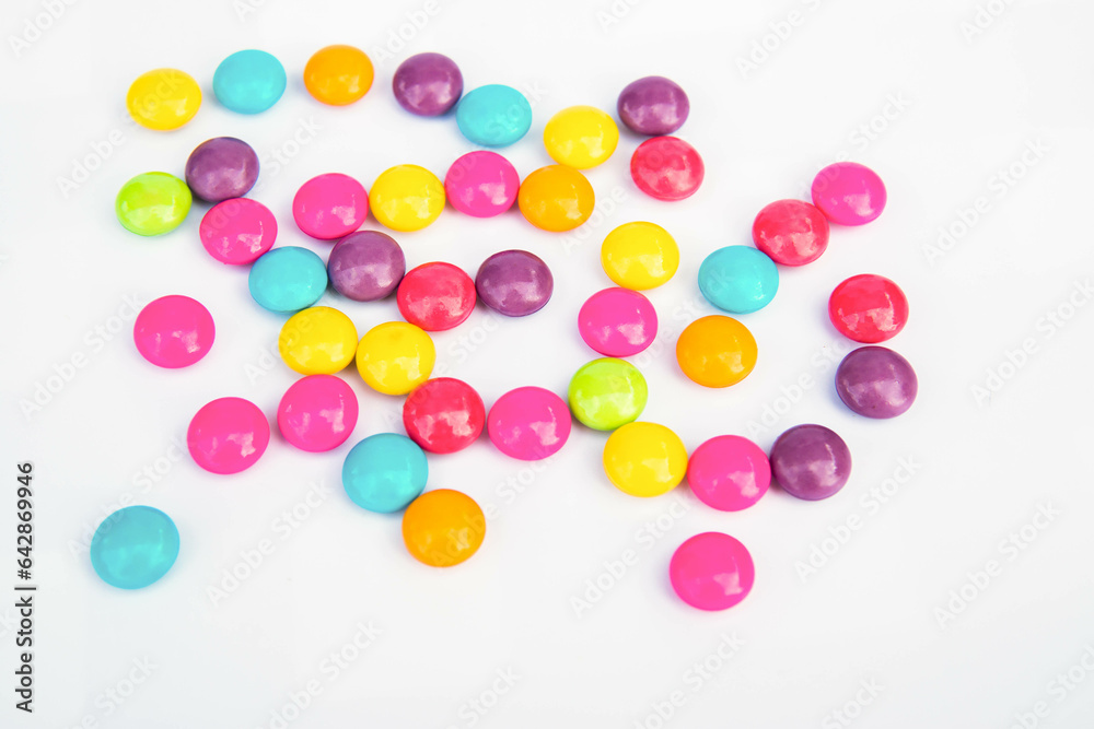 Various colored chocolate candies on a white background