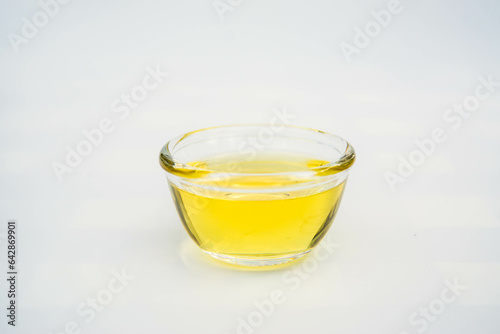 Almond oil with almond grains, white background
