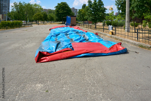 Deflated trampoline,inflatable pool, children's slide in the city park