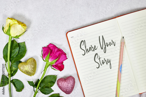 share your story concept om notebook with roses flowers and hearts glitters