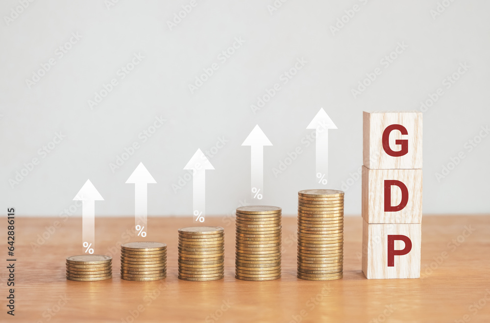 Up golden coin stack with white up arrow on wooden desk with alphabet Up golden coin stack with white up arrow on wooden desk with alphabet