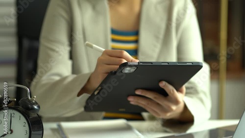 Women use a tablet and work computer. photo