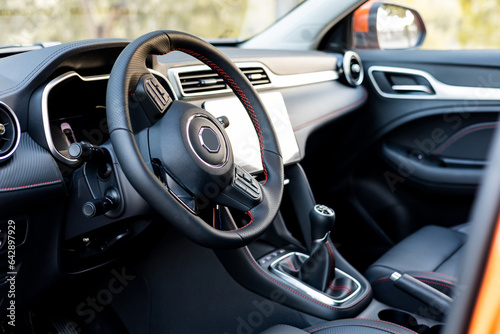 Photo of the interior of a modern SUV vehicle. New hybrid cars, with multimedia touch screen. Concept of black modern vehicle interiors. ©  Yistocking