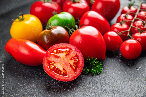 fresh tomato assorted tomatoes ripe fruit harvest type red, yellow, green vegetable meal food snack on the table copy space food background rustic top view © Alesia Berlezova