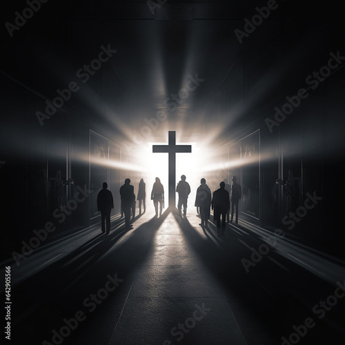 Silouettes of people stand in front of a cross in the light, holy mood photo