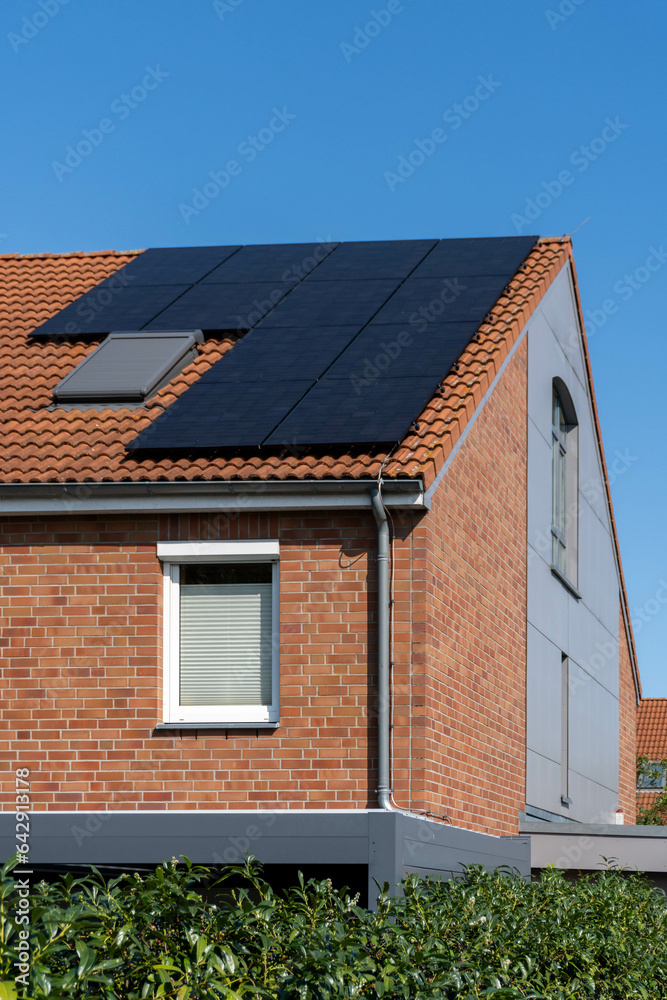 solar panels on roof of a townhouse with bricked facade