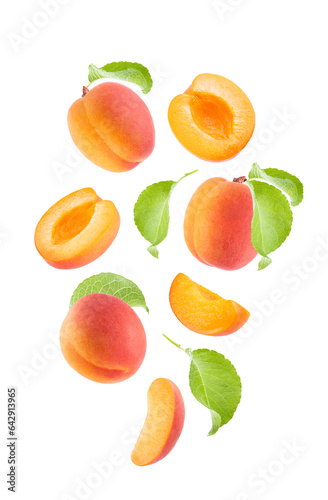 Ripe orange apricot with pink side, green leaves as flow fly or fall as art composition. Whole, half, piece fruits isolated on white background. Summer fruits for advertising, design, label product.