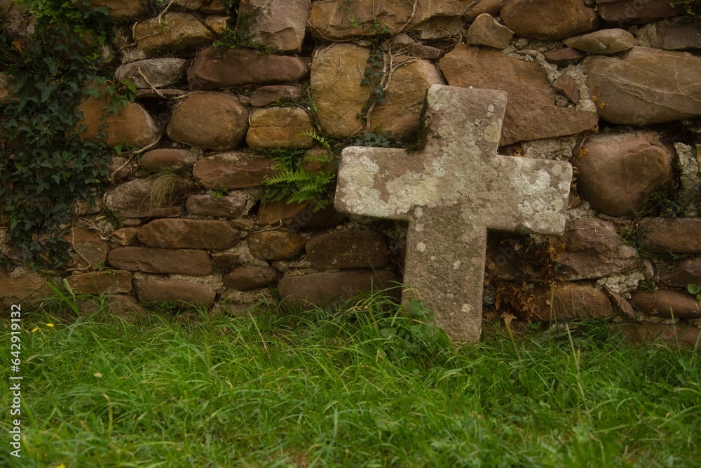 Stone Cross over an ancient stone wall