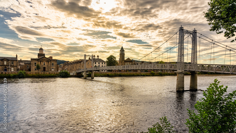Fototapeta premium Suspended walkway that passes over the River Ness in the beautiful city of Inverness at sunset, Scotland.