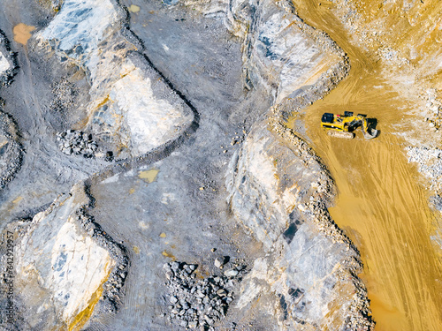 Opencast Mine Aerial View. Industrial terraces in a mining quarry. Open pit mining of dolomite. Excavation machinery of the dolomite mine. Extractive industry. Opencast mining.