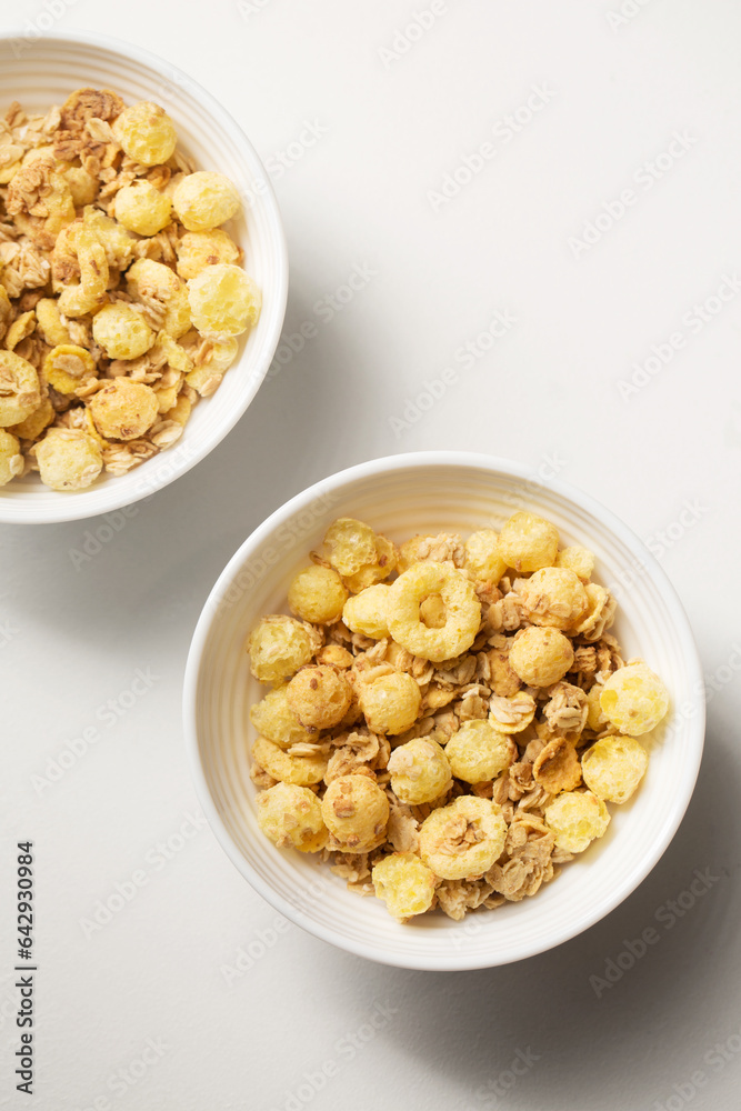 Breakfast with granola in small bowls on a white background