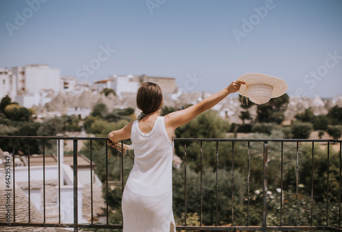 A young woman in a white dr...