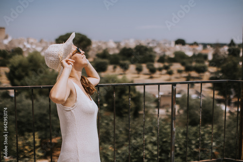 A young woman in a white dr...