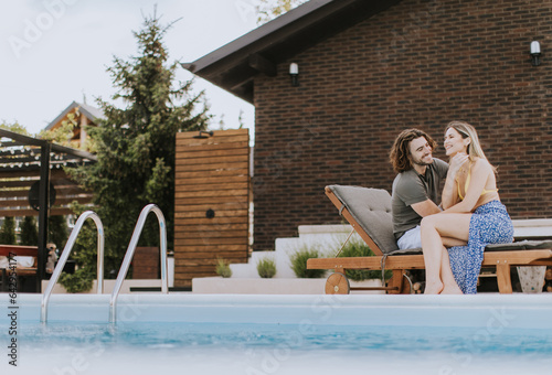 Young couple relaxing by th...