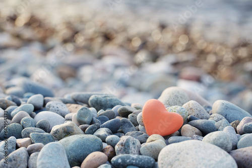 Fototapeta Naklejka Na Ścianę i Meble -  red stone in  shape of heart on  beach by  sea
