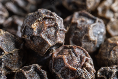 Peppercorns or black pepper spice. Super Macro Close Up. photo