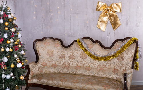 Lnterior with decorated christmas tree and sofa in studio photo