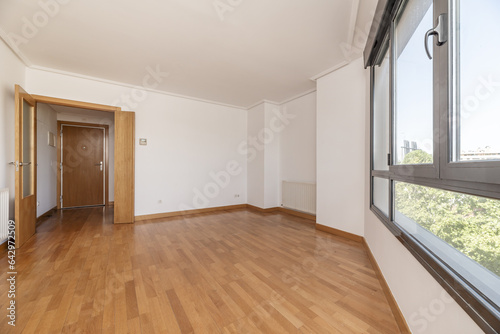 An empty room with wooden floors, white walls © Toyakisfoto.photos