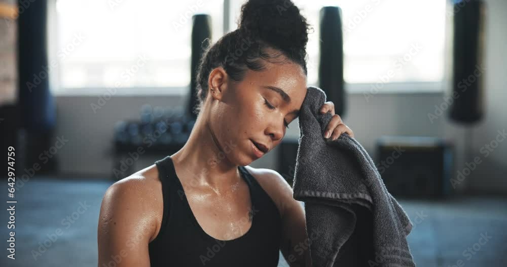 Tired, sweating and towel with woman in gym for breathing, workout and ...