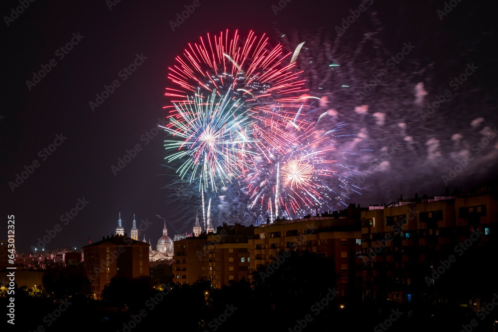 Fireworks for the celebration of the Fiestas del Pilar on the 12th of October with the Basilica del Pilar in the background illuminated by fireworks, Zaragoza, Spain.