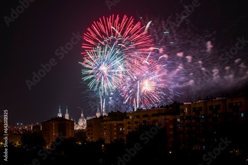 Fireworks for the celebration of the Fiestas del Pilar on the 12th of October with the Basilica del Pilar in the background illuminated by fireworks, Zaragoza, Spain. © Chemari