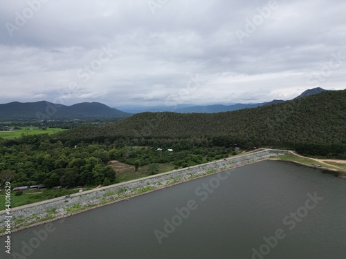 Beautiful natural scenery of a river in Southeast Asia, tropical forest with mountains in the background, aerial view, drone shot.