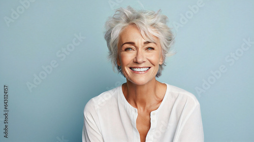 Beautiful gorgeous elderly woman 50s age senior model with grey hair laughing and smiling. Mature old lady close-up portrait. Healthy face skin care beauty, skincare cosmetics, dental, health.
