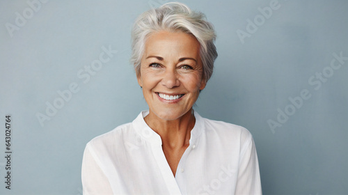 Beautiful gorgeous elderly woman 50s age senior model with grey hair laughing and smiling. Mature old lady close-up portrait. Healthy face skin care beauty, skincare cosmetics, dental, health.