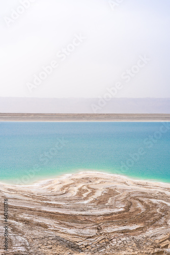 Desert landscape of Dead Sea coastline with white salt in Jordan